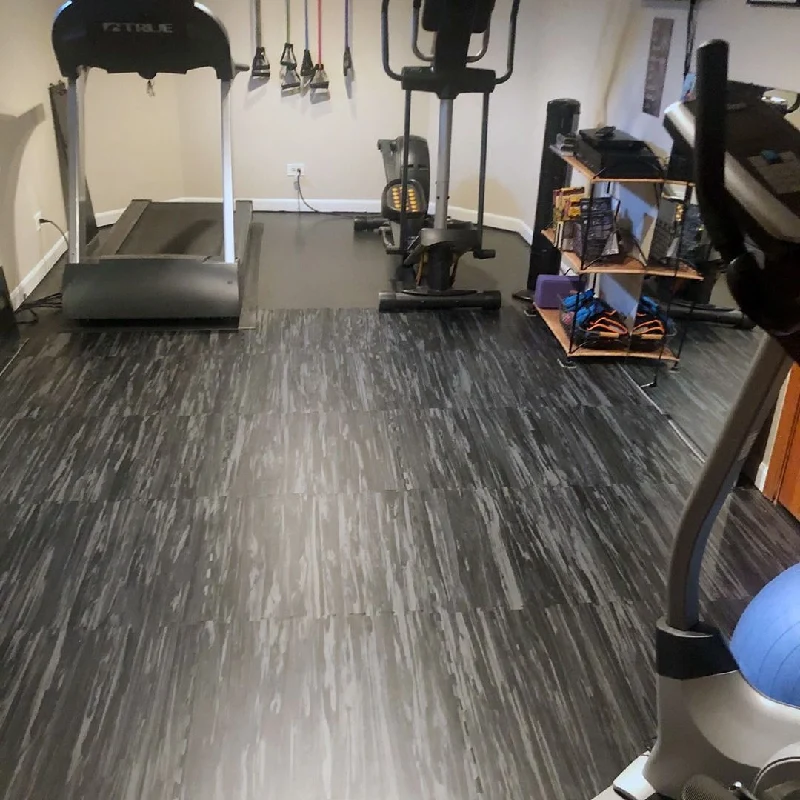 Black and gray striped vinyl floor tiles in a home gym