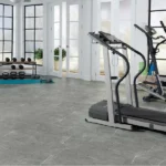 Home gym featuring grey stone-look vinyl flooring with veining.