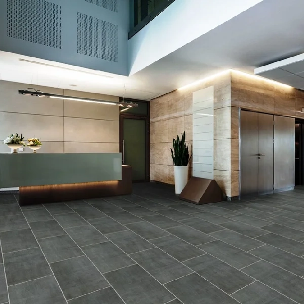 Reception (Dark charcoal stone-look vinyl tile in hotel lobby)