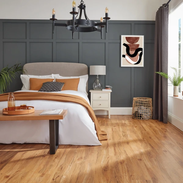 Warm honey oak vinyl plank flooring in modern bedroom